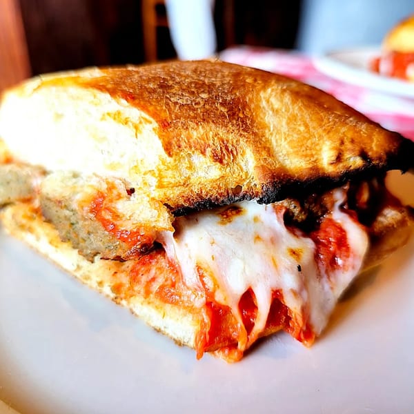 A Baci Trattoria & Pizza meatball sub with melted mozzarella cheese and marinara sauce.
